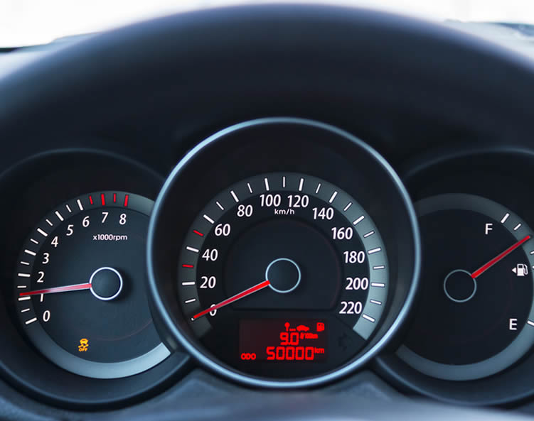 Stylish speedometer, tachometer and fuel gauges on a car dashboard